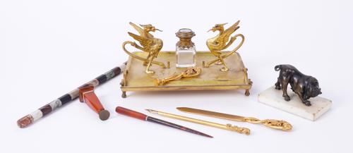 A BRONZE STATUETTE OF A BULL; TOGETHER WITH A GILT-METAL GRIFFIN DESK STAND AND ASSOCIATED DESK ACCESSORIES (9)
