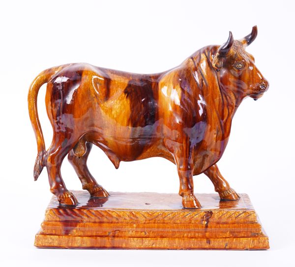 A BROWN GLAZED CERAMIC BULL