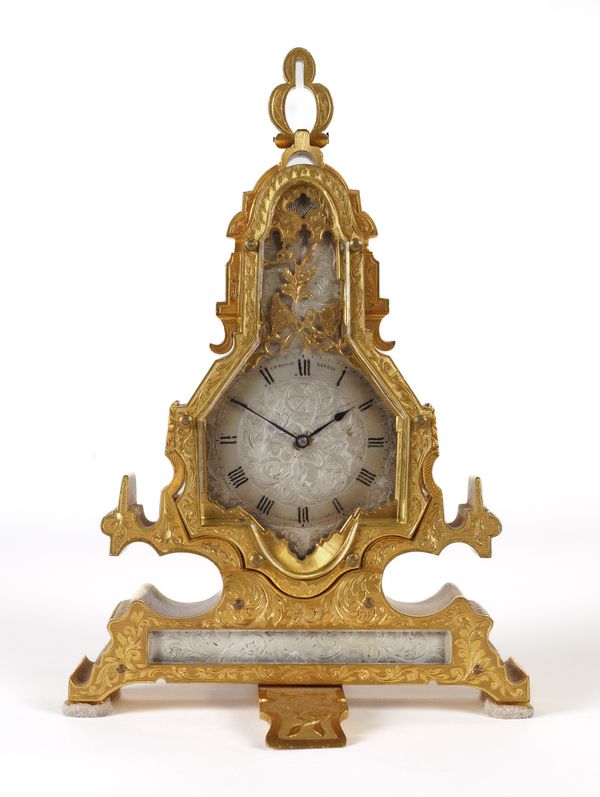 A RARE AND UNUSUAL ENGRAVED GILTBRASS STRUT TIMEPIECE