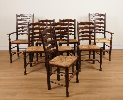 A MATCHED SET OF EIGHT 20TH CENTURY ASH AND OAK LANCASHIRE LADDER BACK DINING CHAIRS (8)