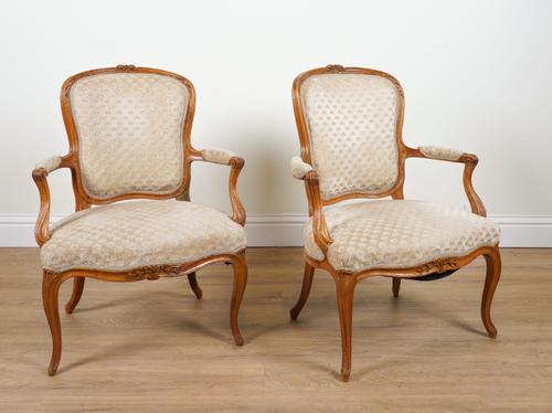A PAIR OF CARVED BEECH FRAMED FRENCH LOUIS XV STYLE OPEN ARMCHAIRS