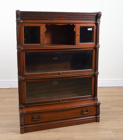 GLOBE WERNICKE & CO LTD; A WALNUT FOUR TIER BOOKCASE WITH BEVELLED GLAZED PANELS, SINGLE DRAWER BASE AND FIELDED PANELLED SIDES