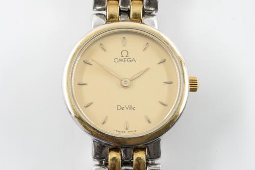 AN OMEGA DE VILLE STEEL AND GILT METAL LADY'S BRACELET WATCH