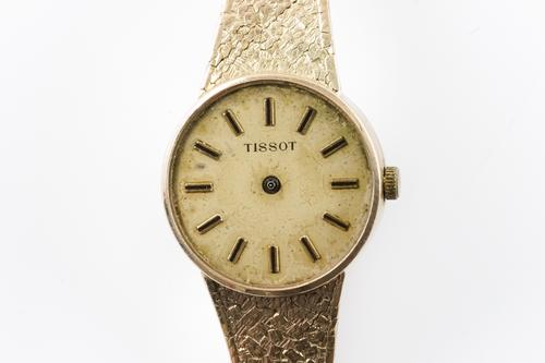 A TISSOT 9CT GOLD LADY'S BRACELET WRISTWATCH
