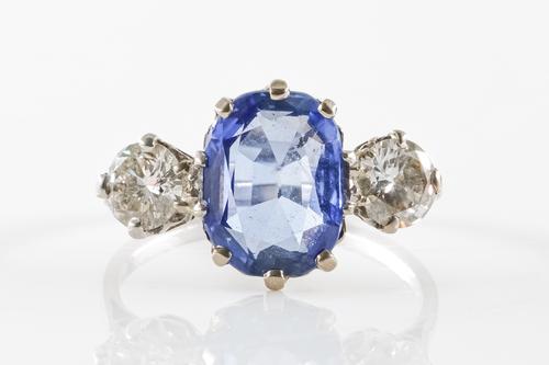 A SAPPHIRE AND DIAMOND THREE STONE RING