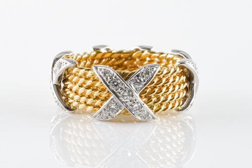 A DIAMOND AND GOLD CROSS OVER RING