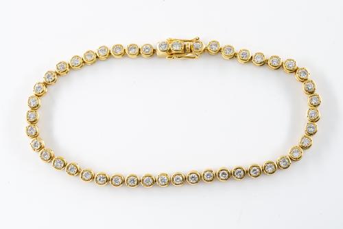 A DIAMOND LINE BRACELET IN 18CT YELLOW GOLD