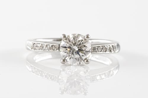 A DIAMOND RING WITH DIAMOND SET SHOULDERS
