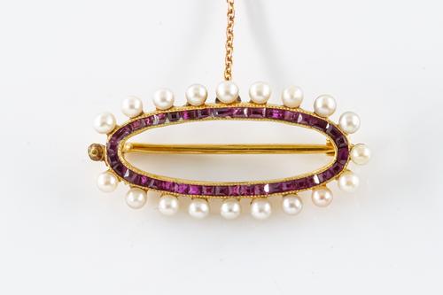 A RUBY AND SEED PEARL BROOCH
