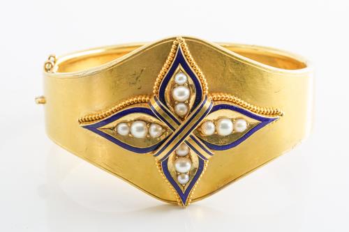 A VICTORIAN PEARL AND BLUE ENAMEL BANGLE/CUFF