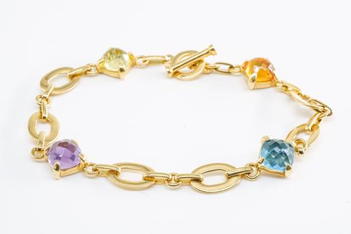 A GEM SET BRACELET IN 18CT GOLD