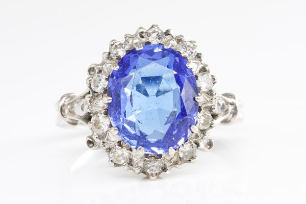 A WHITE GOLD, TANZANITE AND DIAMOND OVAL CLUSTER RING