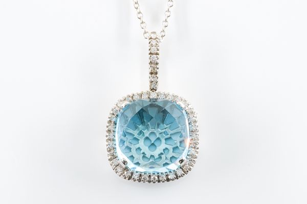 A WHITE GOLD, BLUE TOPAZ AND DIAMOND PENDANT