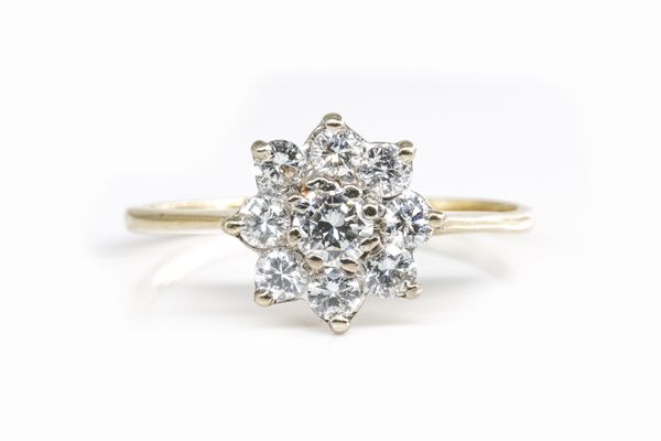 A GOLD AND DIAMOND NINE STONE CLUSTER RING