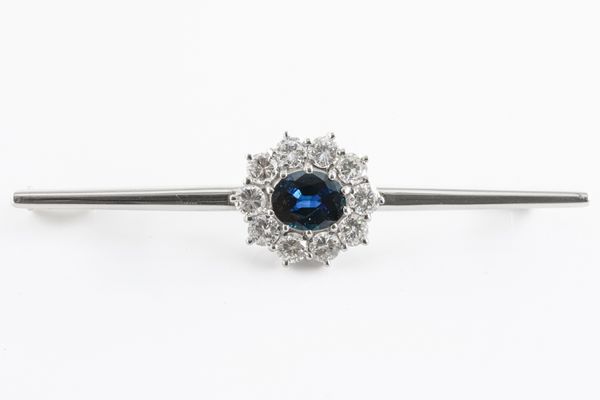 A SAPPHIRE AND DIAMOND OVAL CLUSTER BAR BROOCH