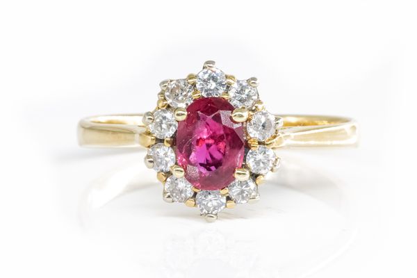 A RUBY AND DIAMOND OVAL CLUSTER RING