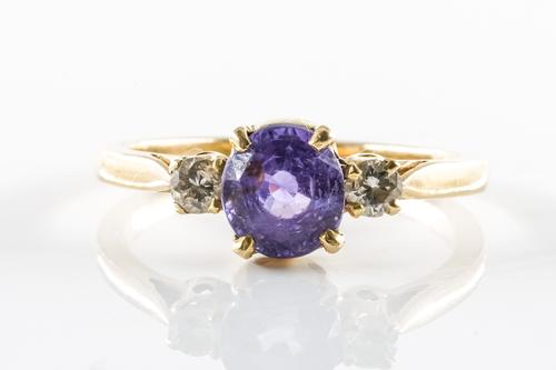 A SAPPHIRE AND DIAMOND SET THREE STONE RING
