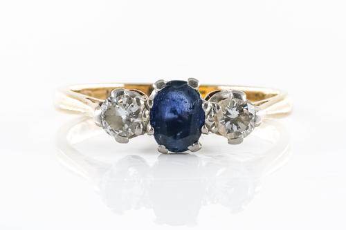 A SAPPHIRE AND DIAMOND THREE STONE RING