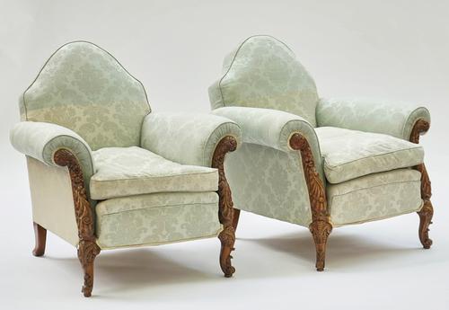 A pair carved walnut framed humpback easy armchairs