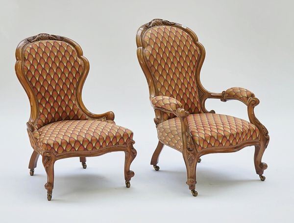 A pair of Victorian mahogany framed lady's and gentleman's easy chairs