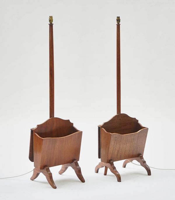 A pair of  walnut standard lamps with integral magazine rack and drop flap table