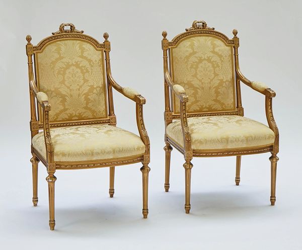 A pair of Louis XVI style gilt framed open armchairs