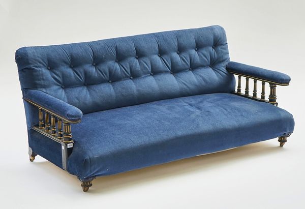 A VICTORIAN PARCEL-GILT EBONISED OPEN ARM SOFA