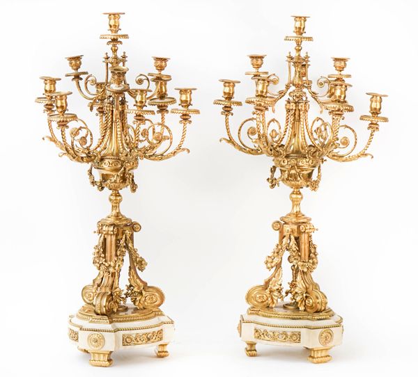 A pair of French gilt-metal and white marble ten-light candelabra