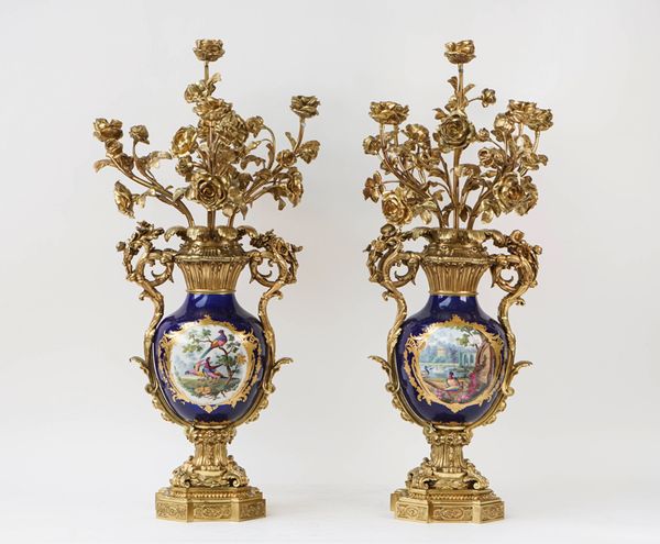 A pair of French gilt-metal and porcelain five light candelabra