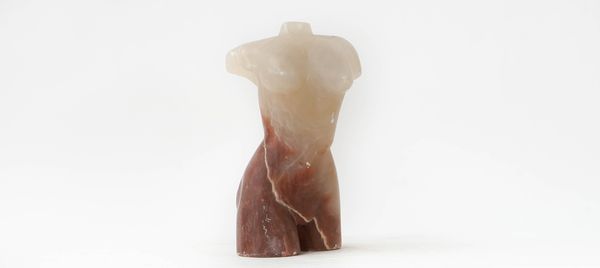 An alabaster sculpture of a female torso