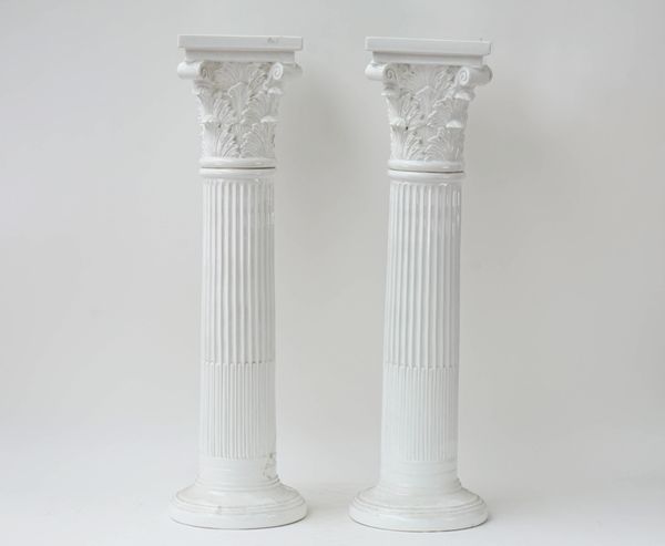 A pair of white glazed pottery columns