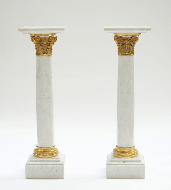 A pair of gilt-metal mounted white marble columns