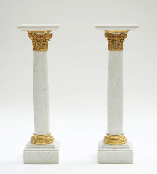 A pair of gilt-metal mounted white marble columns