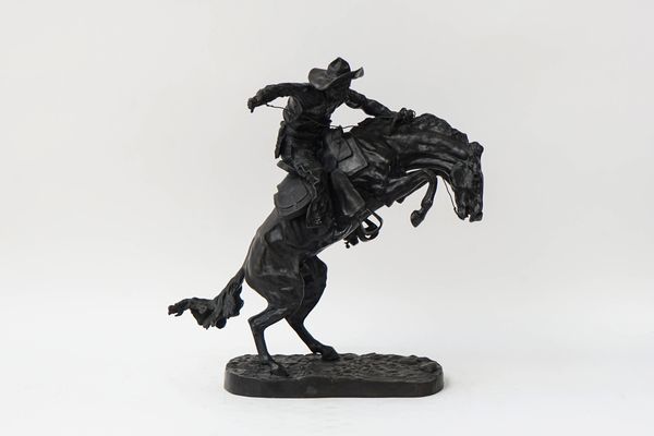 A BRONZE SCULPTURE 'THE BRONCHO BUSTER'