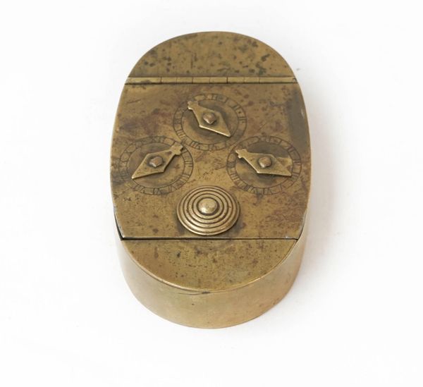 An oval brass three-dial combination lock snuff/tobacco box