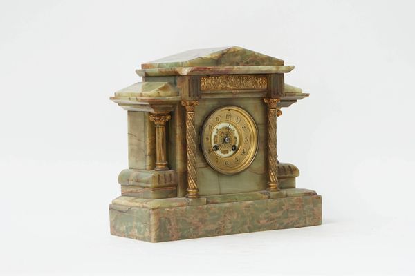 A FRENCH ONYX AND GILT-METAL MOUNTED MANTEL CLOCK