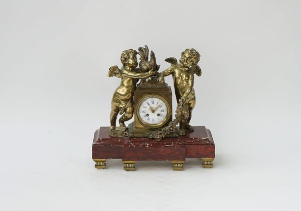 A French gilt-metal and rouge marble mantel clock