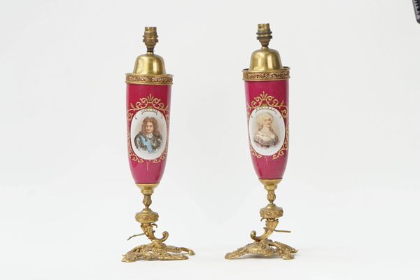 A pair of French gilt-metal and porcelain table lamps