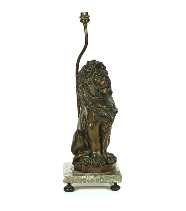 A VICTORIAN BRONZE MODEL OF A SEATED LION AFTER ALFRED STEVENS (1817-1875)