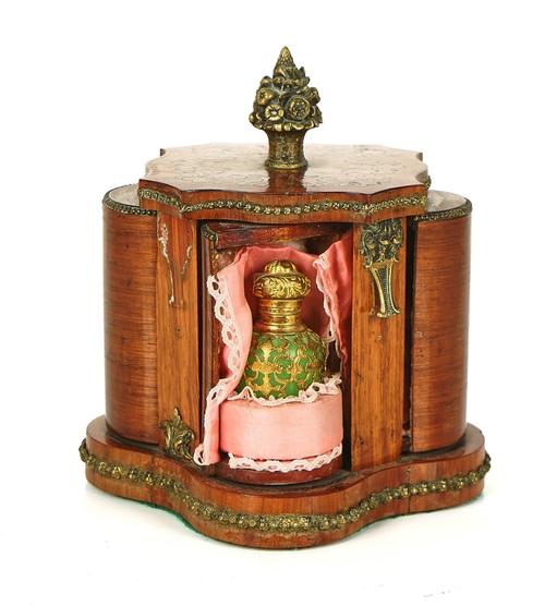 A FRENCH GILT-METAL MOUNTED TULIPWOOD REVOLVING SCENT BOTTLE HOLDER