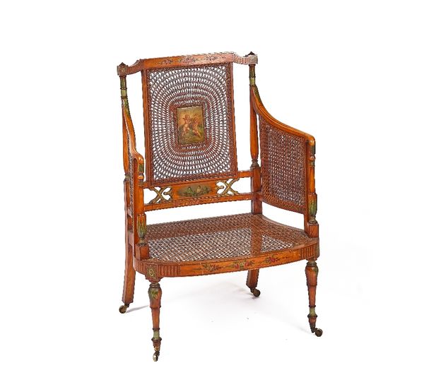 AN EDWARDIAN POLYCHROME PAINTED SATINWOOD AND CANEWORK ARMCHAIR