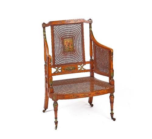AN EDWARDIAN POLYCHROME PAINTED SATINWOOD AND CANEWORK ARMCHAIR