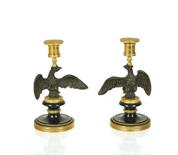 A PAIR OF REGENCY GILT AND PATINATED BRONZE EAGLE CANDLESTICKS