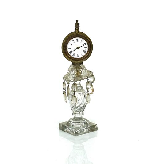 A BRASS SEDAN CLOCK LATER MOUNTED ON A CUT-GLASS CANDLESTICK