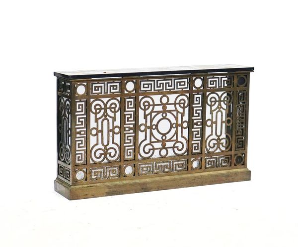 A MARBLE MOUNTED BRASS ALLOY RADIATOR COVER