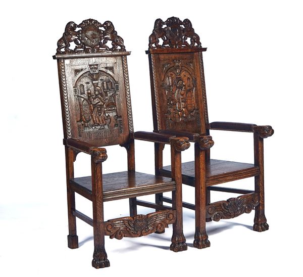 A PAIR OF CARVED OAK OPENARM THRONE CHAIRS (2)