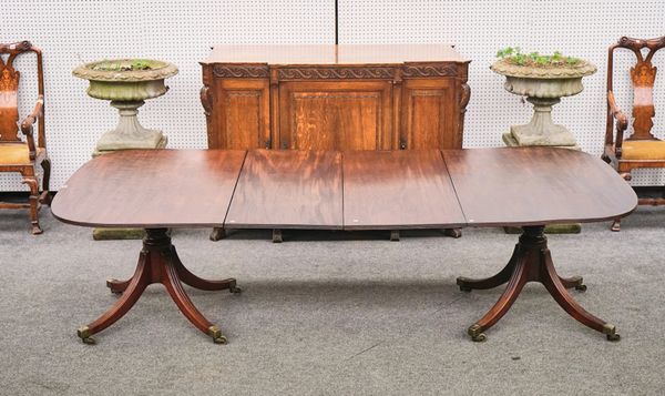 A GEORGE III MAHOGANY TWIN PEDESTAL EXTENDING DINING TABLE