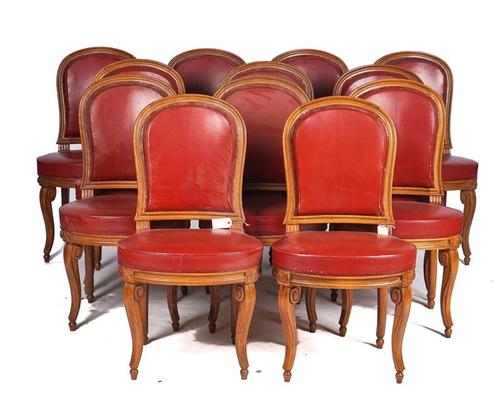 A SET OF TWELVE BEECH FRAMED LOUIS XVI  STYLE, RED LEATHER UPHOLSTERED DINING CHAIRS (12)