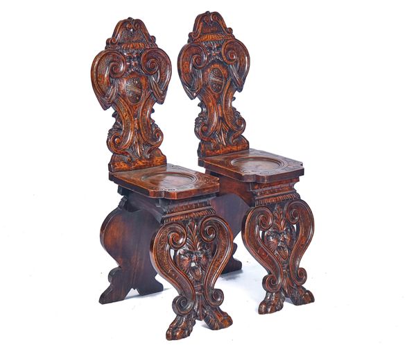 A PAIR OF 19TH CENTURY ITALIAN CARVED WALNUT HALL CHAIRS (2)