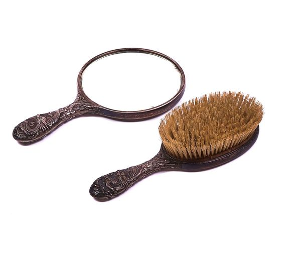 A CHINESE EXPORT SILVER MOUNTED HAND MIRROR AND HAIRBRUSH